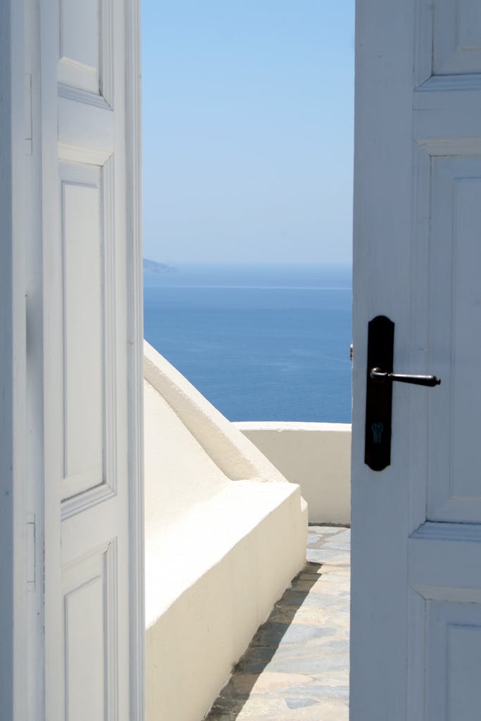 White Wooden Door Near Body of Water